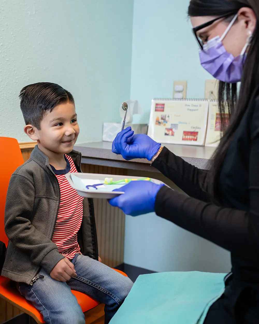 Dentist With Young Boy In Office