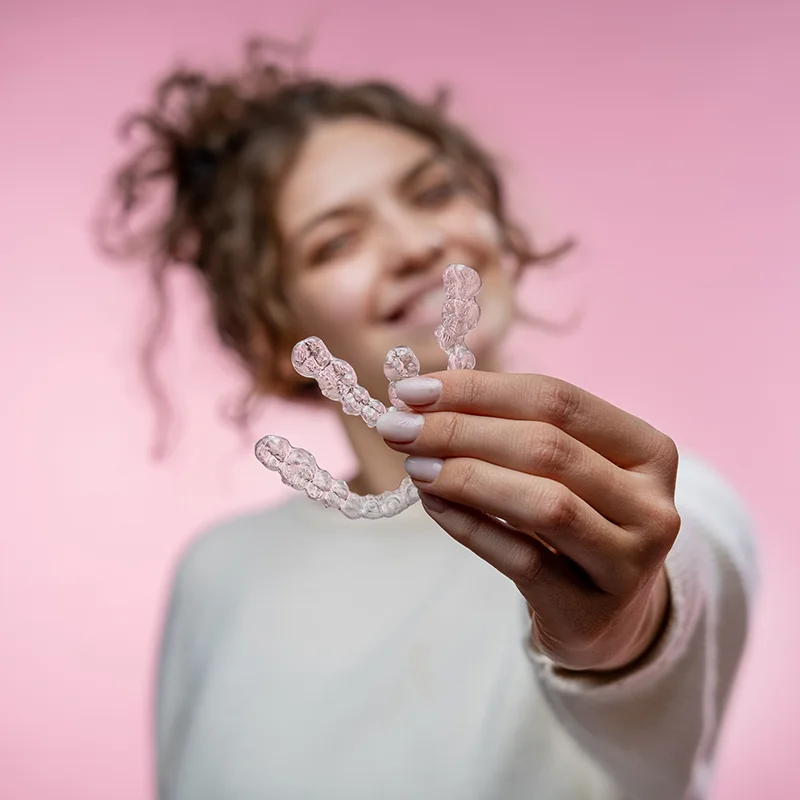 Girl Holding Invisalign Trays